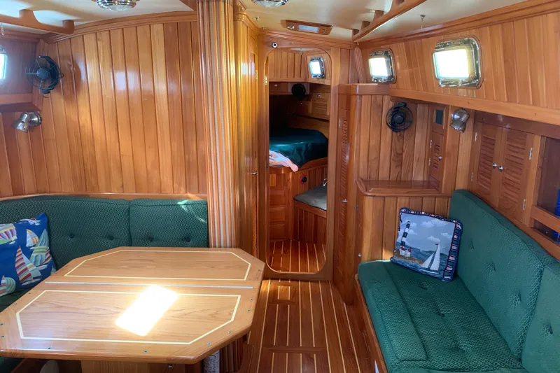 Elation Yacht Photos Pics Luxurious 2004 Cabo Rico 42 Pilot yacht interior with wood paneling and green seating.