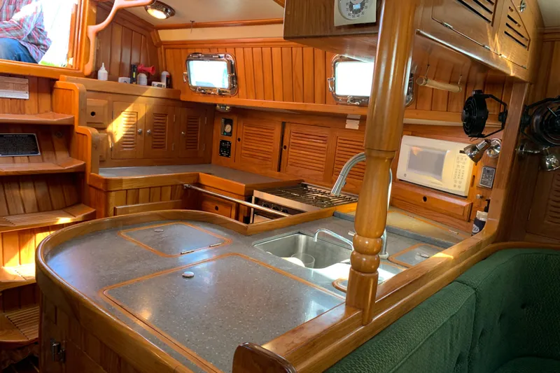 Elation Yacht Photos Pics 2004 Cabo Rico 42 Pilot yacht interior with wooden cabinetry and modern kitchen amenities.