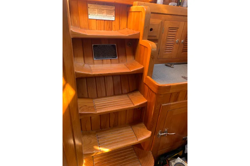Elation Yacht Photos Pics Wooden interior stairs of 2004 Cabo Rico 42 Pilot yacht, featuring warm tones and cabinetry.