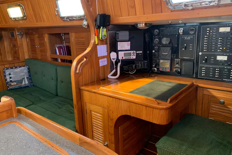 Elation Yacht Photos Pics Interior of 2004 Cabo Rico 42 Pilot yacht with navigation station and seating area.