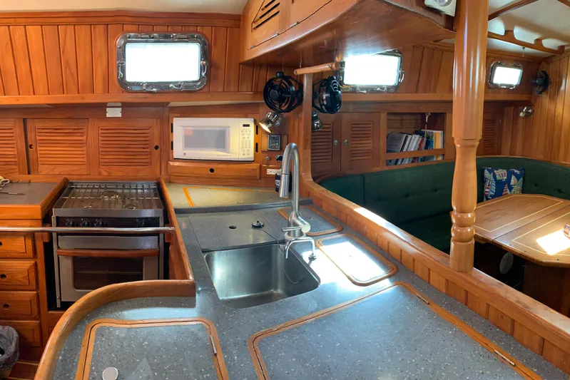 Elation Yacht Photos Pics Luxurious 2004 Cabo Rico 42 Pilot yacht interior with kitchen and dining area.