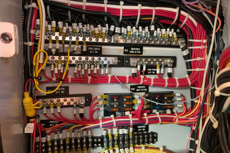 Elation Yacht Photos Pics Electrical panel of a 2004 Cabo Rico 42 Pilot, showcasing organized wiring and labeled connections.