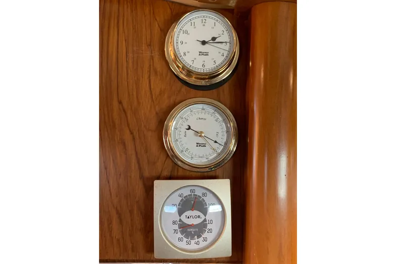 Elation Yacht Photos Pics Nautical instruments on 2004 Cabo Rico 42 Pilot, featuring clock, barometer, and hygrometer.
