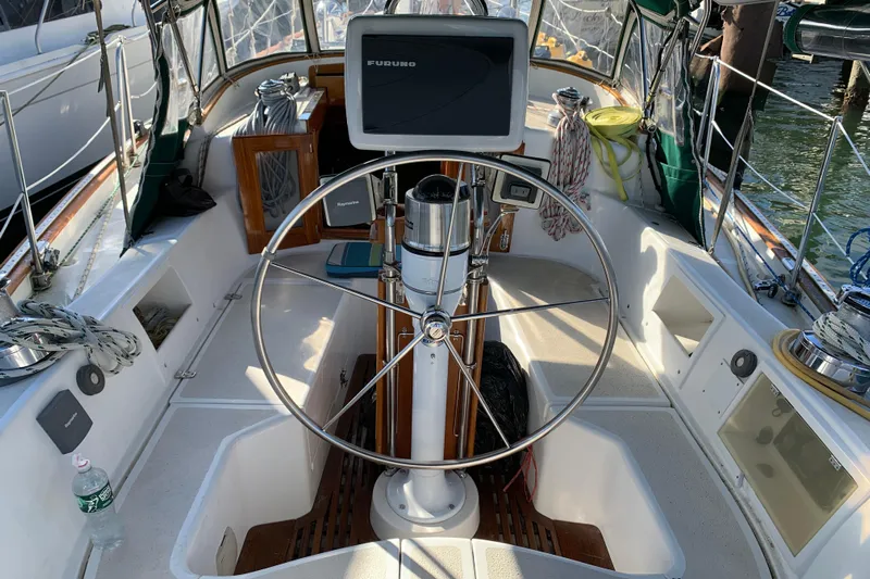 Elation Yacht Photos Pics 2004 Cabo Rico 42 Pilot sailboat cockpit with steering wheel and navigation equipment.