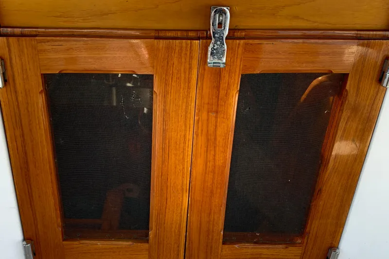 Elation Yacht Photos Pics Wooden cabin doors on a 2004 Cabo Rico 42 Pilot yacht.