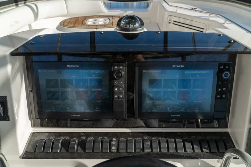  Yacht Photos Pics 2008 Sea Ray 58 Sedan Bridge helm with dual Raymarine displays and control panel.
