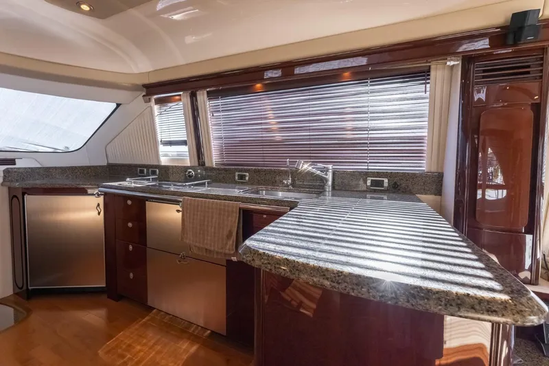  Yacht Photos Pics Luxurious kitchen interior of 2008 Sea Ray 58 Sedan Bridge yacht with granite countertops.