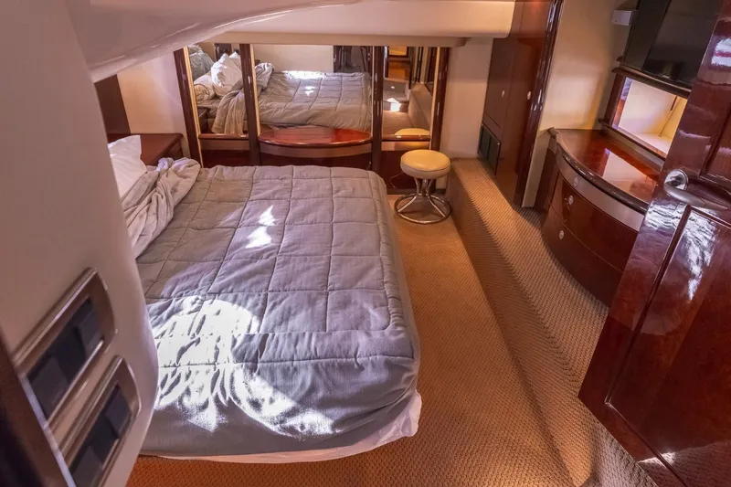  Yacht Photos Pics Luxurious 2008 Sea Ray 58 Sedan Bridge bedroom with elegant wood finishes and cozy bedding.