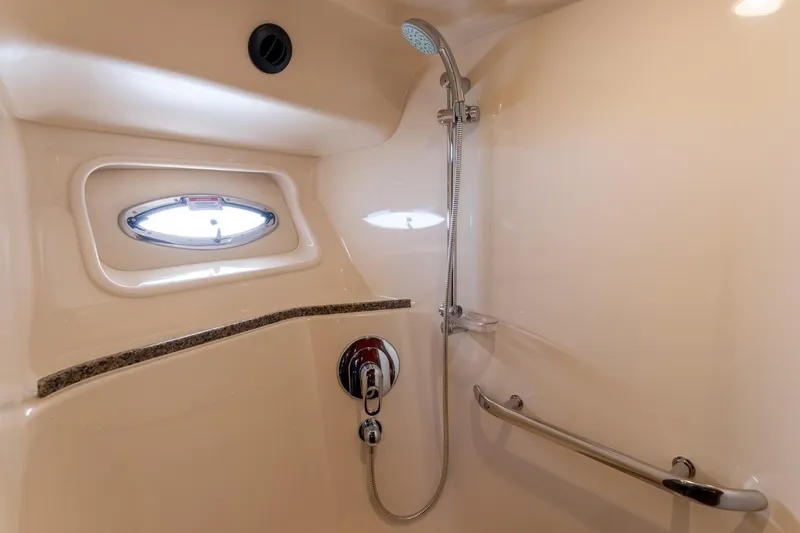  Yacht Photos Pics Luxurious shower area in 2008 Sea Ray 58 Sedan Bridge yacht, featuring sleek fixtures and porthole window.