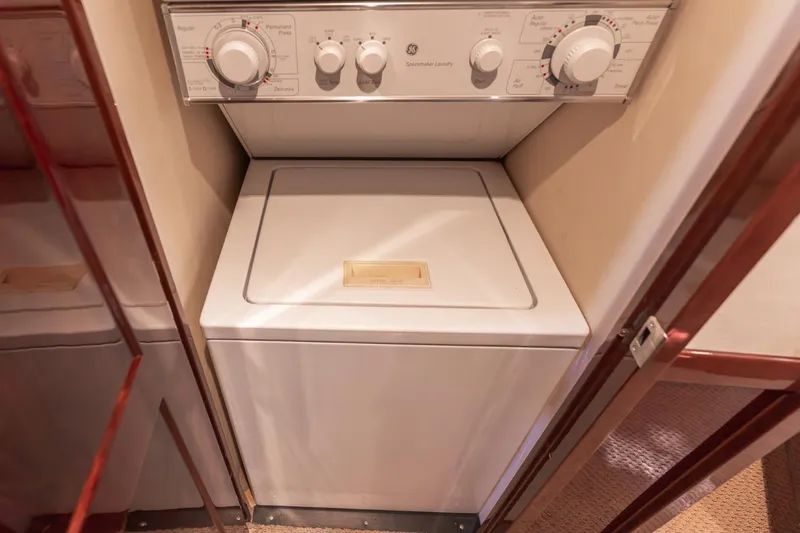  Yacht Photos Pics Laundry area inside 2008 Sea Ray 58 Sedan Bridge yacht, featuring a compact washing machine.
