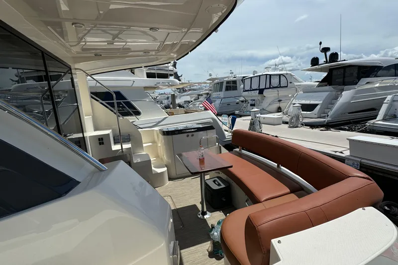  Yacht Photos Pics 2017 Carver C40 Command Bridge yacht with outdoor seating at a marina.