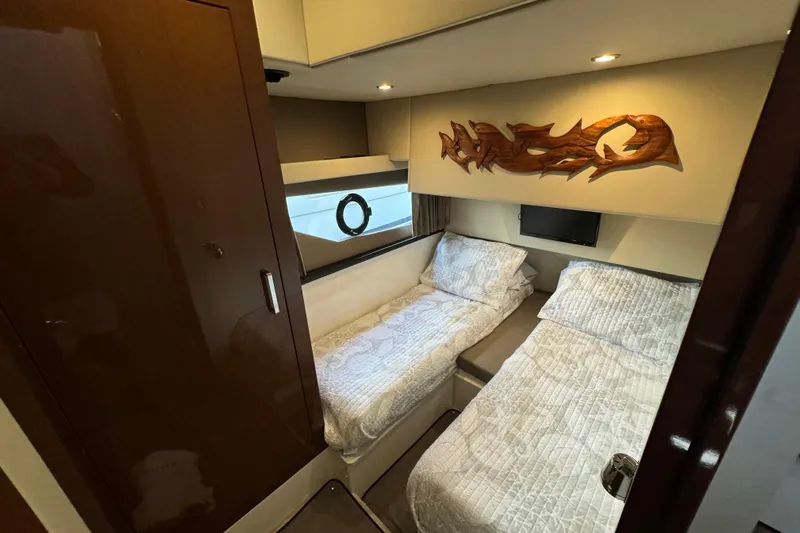  Yacht Photos Pics Interior of 2017 Carver C40 Command Bridge with twin beds and decorative wall art.