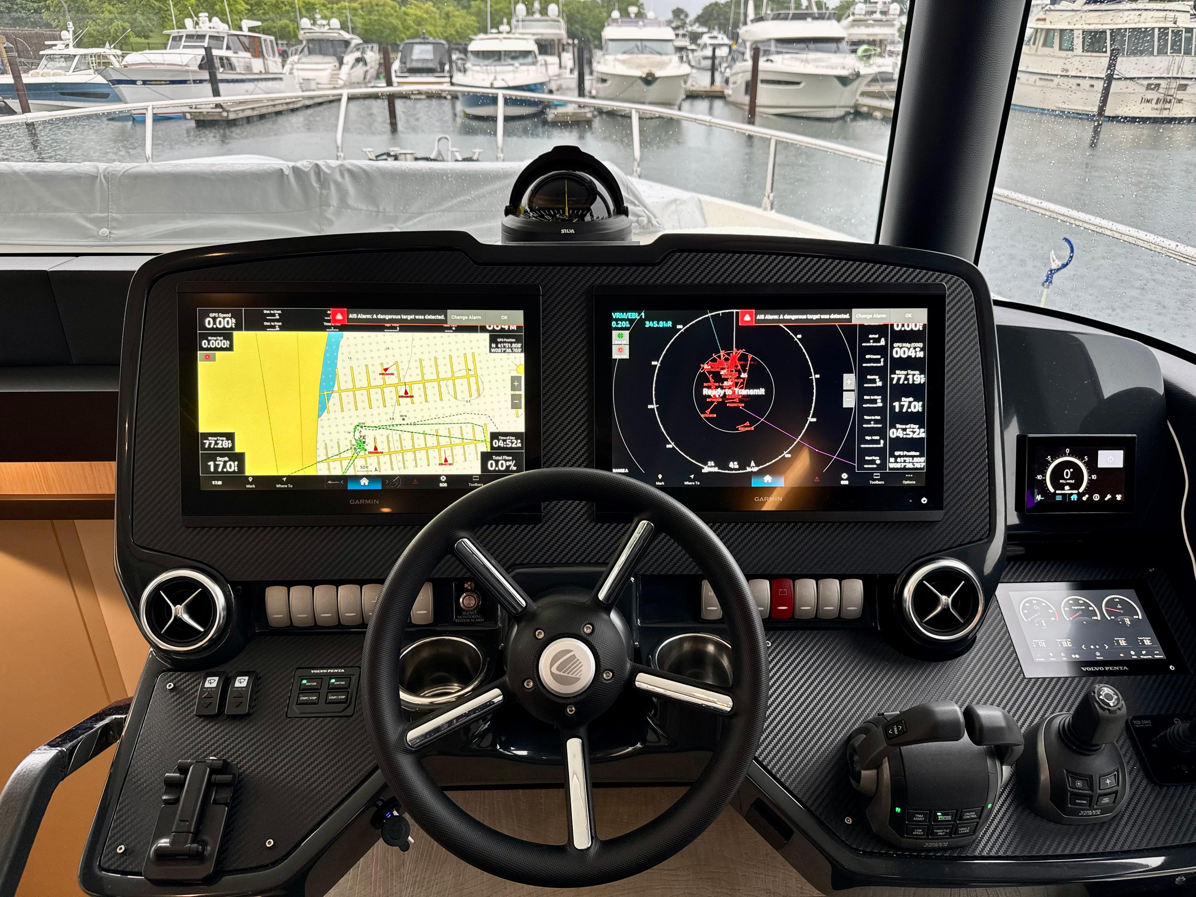 Cockpit of 2023 Absolute 52 Navetta yacht with advanced navigation displays.