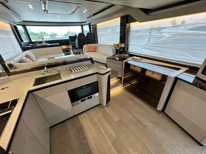 Just You Yacht Photos Pics Luxurious interior of 2023 Absolute 52 Navetta yacht with modern kitchen and seating area.