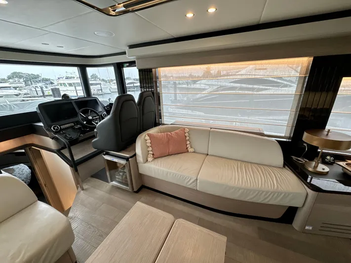 Just You Yacht Photos Pics Luxurious interior of 2023 Absolute 52 Navetta yacht with modern seating and helm.