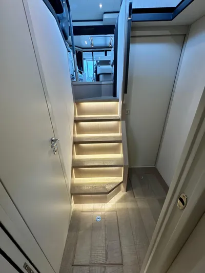 Just You Yacht Photos Pics Interior staircase of 2023 Absolute 52 Navetta yacht, featuring modern lighting and sleek design.