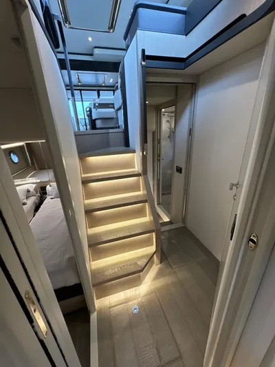 Just You Yacht Photos Pics Luxurious interior of 2023 Absolute 52 Navetta yacht with illuminated stairs and modern design.