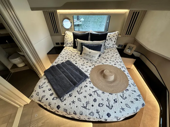 Just You Yacht Photos Pics Luxurious bedroom interior of 2023 Absolute 52 Navetta yacht with nautical-themed decor.