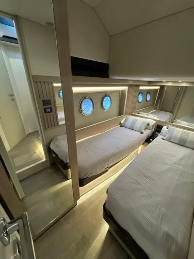 Just You Yacht Photos Pics Luxurious cabin interior of 2023 Absolute 52 Navetta yacht with twin beds and portholes.