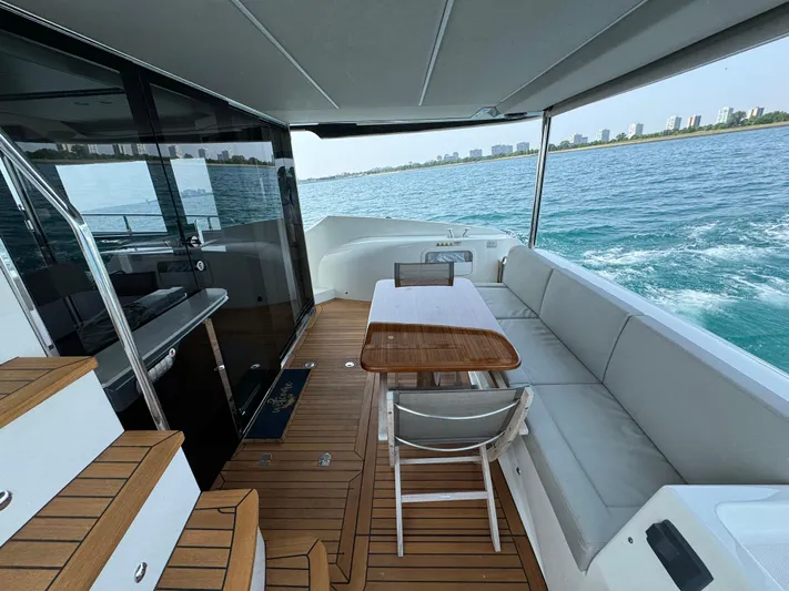 Just You Yacht Photos Pics Luxurious 2023 Absolute 52 Navetta yacht deck with seating and ocean view.