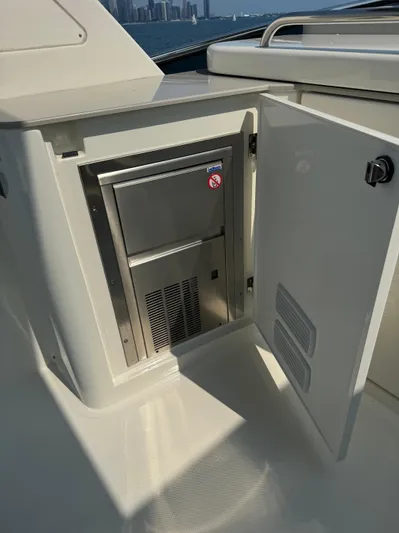 Just You Yacht Photos Pics 2023 Absolute 52 Navetta yacht with open cabinet and built-in appliance.