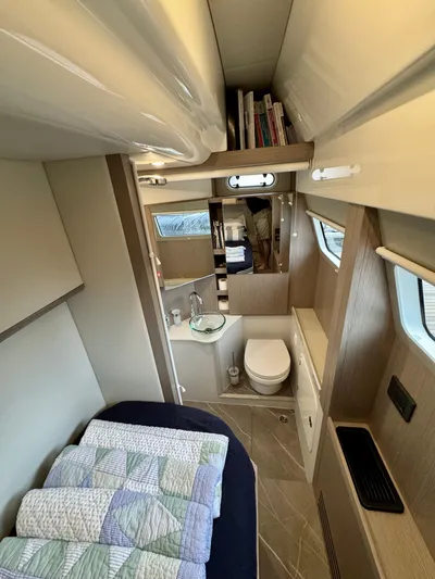 Just You Yacht Photos Pics Interior of 2023 Absolute 52 Navetta yacht with bed, bathroom, and modern design.