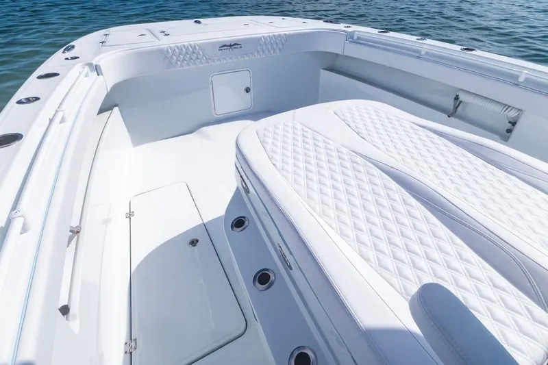  Yacht Photos Pics 2026 Invincible 33 Catamaran with luxurious white seating and spacious deck on the water.