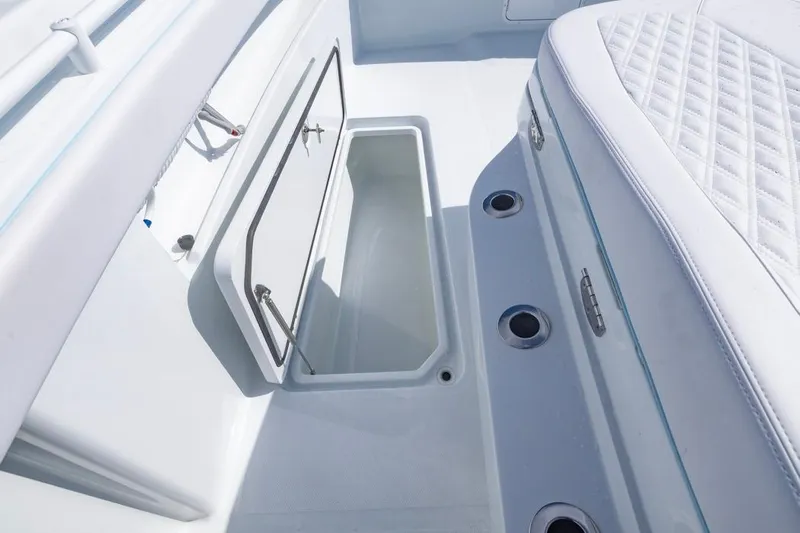  Yacht Photos Pics 2026 Invincible 33 Catamaran interior storage compartment with open hatch and cushioned seating.