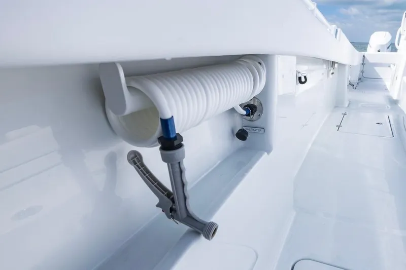  Yacht Photos Pics 2026 Invincible 33 Catamaran deck with coiled hose and saltwater outlet.