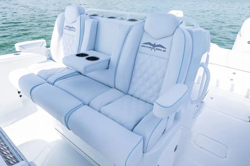  Yacht Photos Pics Luxurious seating on 2026 Invincible 33 Catamaran, featuring plush white upholstery and cup holders.
