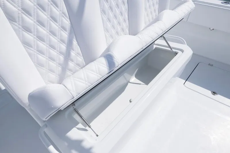  Yacht Photos Pics 2026 Invincible 33 Catamaran with open storage compartment and quilted white seating.