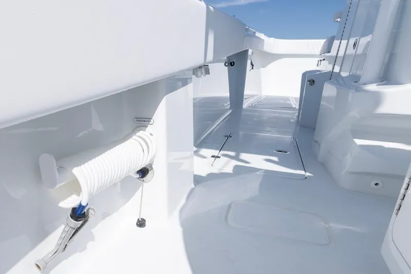  Yacht Photos Pics 2026 Invincible 33 Catamaran deck with freshwater hose, sleek white design.