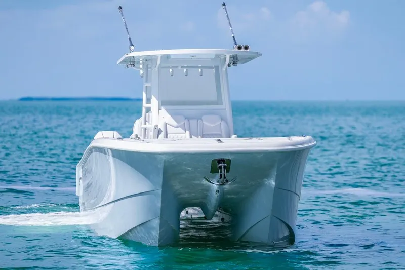  Yacht Photos Pics 2026 Invincible 33 Catamaran cruising on clear blue ocean waters.