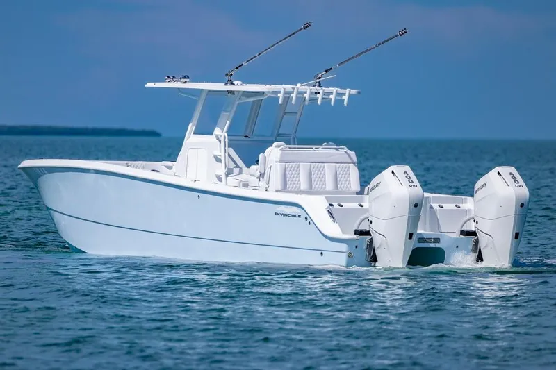  Yacht Photos Pics 2026 Invincible 33 Catamaran cruising on open water, showcasing sleek design and powerful engines.