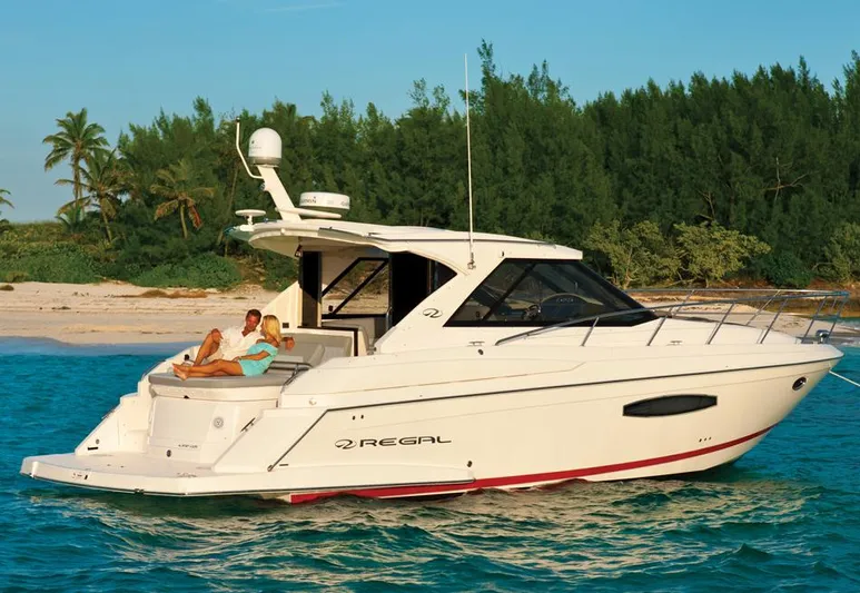 Sea Wolf Yacht Photos Pics Manufacturer Provided Image: 2013 Regal 42 Sport Coupe yacht cruising near a tropical beach.
