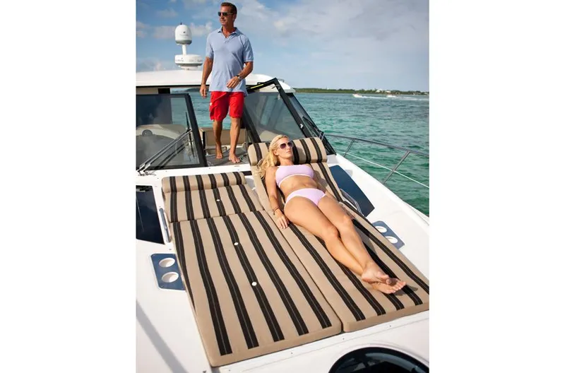 Sea Wolf Yacht Photos Pics Manufacturer Provided Image: Couple relaxing on a 2013 Regal 42 Sport Coupe yacht in sunny weather.
