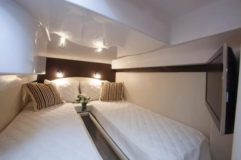  Yacht Photos Pics Manufacturer Provided Image: 2015 Regal 42 Sport Coupe cabin with twin beds, modern lighting, and striped pillows.