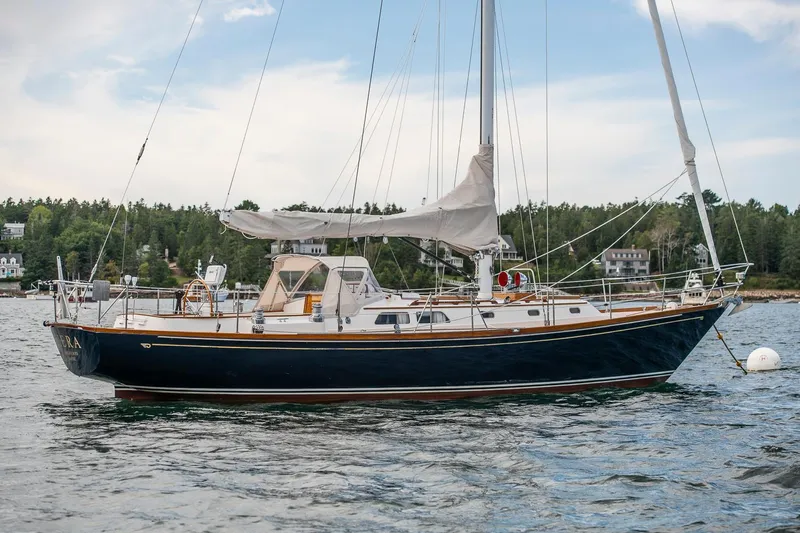 Hera Yacht Photos Pics Hinckley Sou'wester 42 Sloop, 1994, sailing on calm waters with scenic background.
