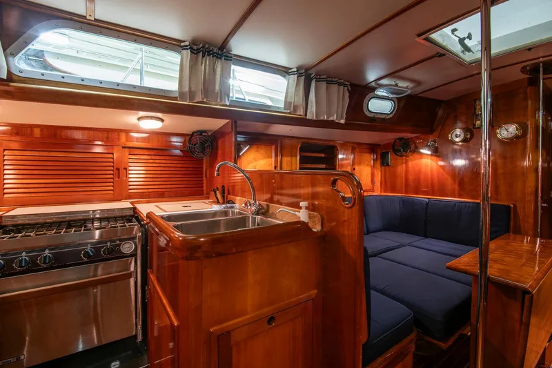 Hera Yacht Photos Pics Interior of 1994 Hinckley Sou'wester 42 Sloop with wood finish and cozy seating area.