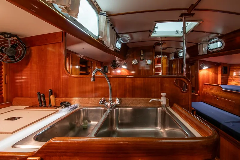 Hera Yacht Photos Pics Interior of 1994 Hinckley Sou'wester 42 Sloop, featuring a wooden galley with a double sink.