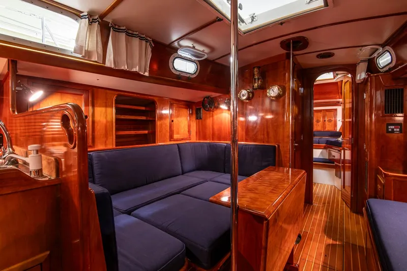 Hera Yacht Photos Pics Luxurious 1994 Hinckley Sou'wester 42 Sloop interior with rich wood finish and blue seating.