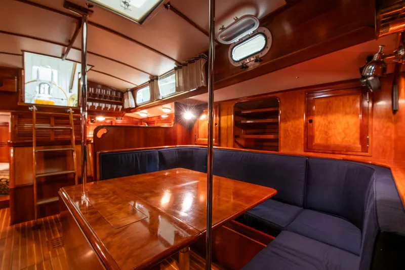 Hera Yacht Photos Pics Interior of 1994 Hinckley Sou'wester 42 Sloop with wooden finishes and blue seating.