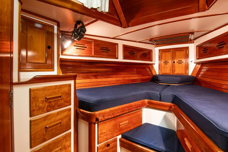 Hera Yacht Photos Pics Luxurious wooden interior of 1994 Hinckley Sou'wester 42 Sloop with blue cushions.
