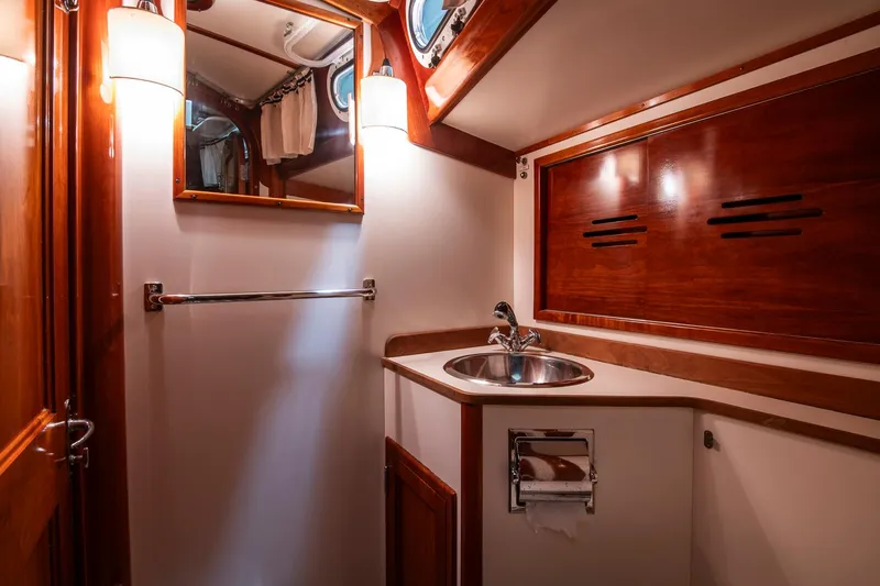 Hera Yacht Photos Pics Luxurious 1994 Hinckley Sou'wester 42 Sloop bathroom with wood accents and modern fixtures.