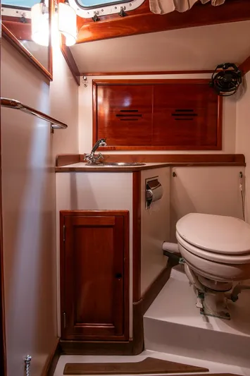 Hera Yacht Photos Pics Hinckley Sou'wester 42 Sloop 1994 bathroom with wooden cabinetry and compact design.