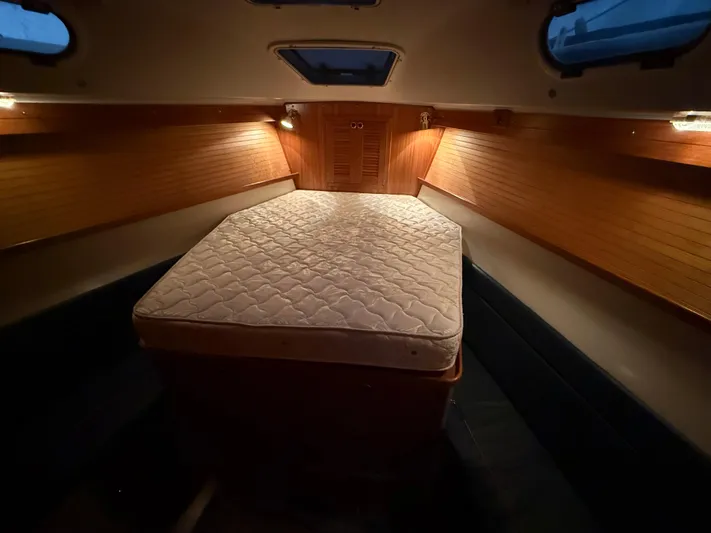 Windquest Yacht Photos Pics Cozy cabin interior of 2001 Catalina 42 MkII sailboat with mattress and warm lighting.