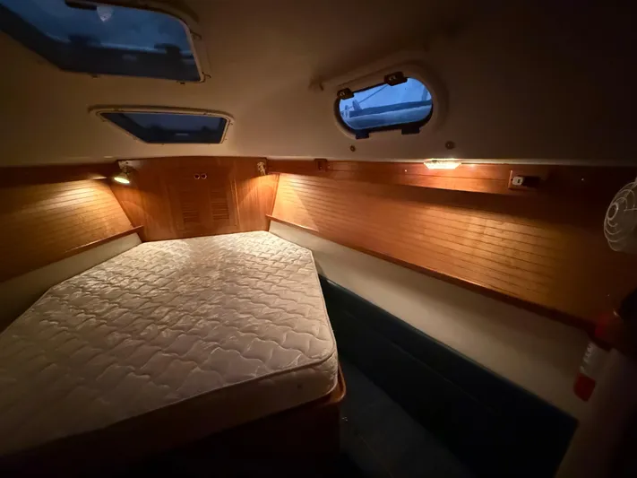 Windquest Yacht Photos Pics Cozy cabin interior of 2001 Catalina 42 MkII sailboat with wooden accents and mattress.