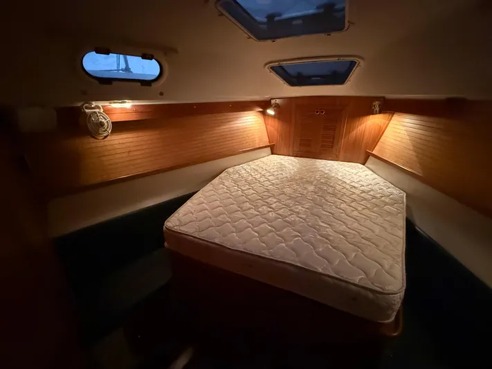 Windquest Yacht Photos Pics Cozy cabin interior of 2001 Catalina 42 MkII sailboat with mattress and warm lighting.