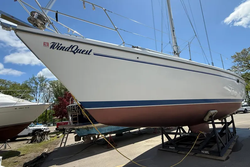 Windquest Yacht Photos Pics Catalina 42 MkII sailboat from 2001, named "WindQuest," on a stand under a clear sky.