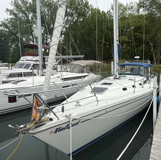 Windquest Yacht Photos Pics 2001 Catalina 42 MkII sailboat docked in a marina, surrounded by trees.